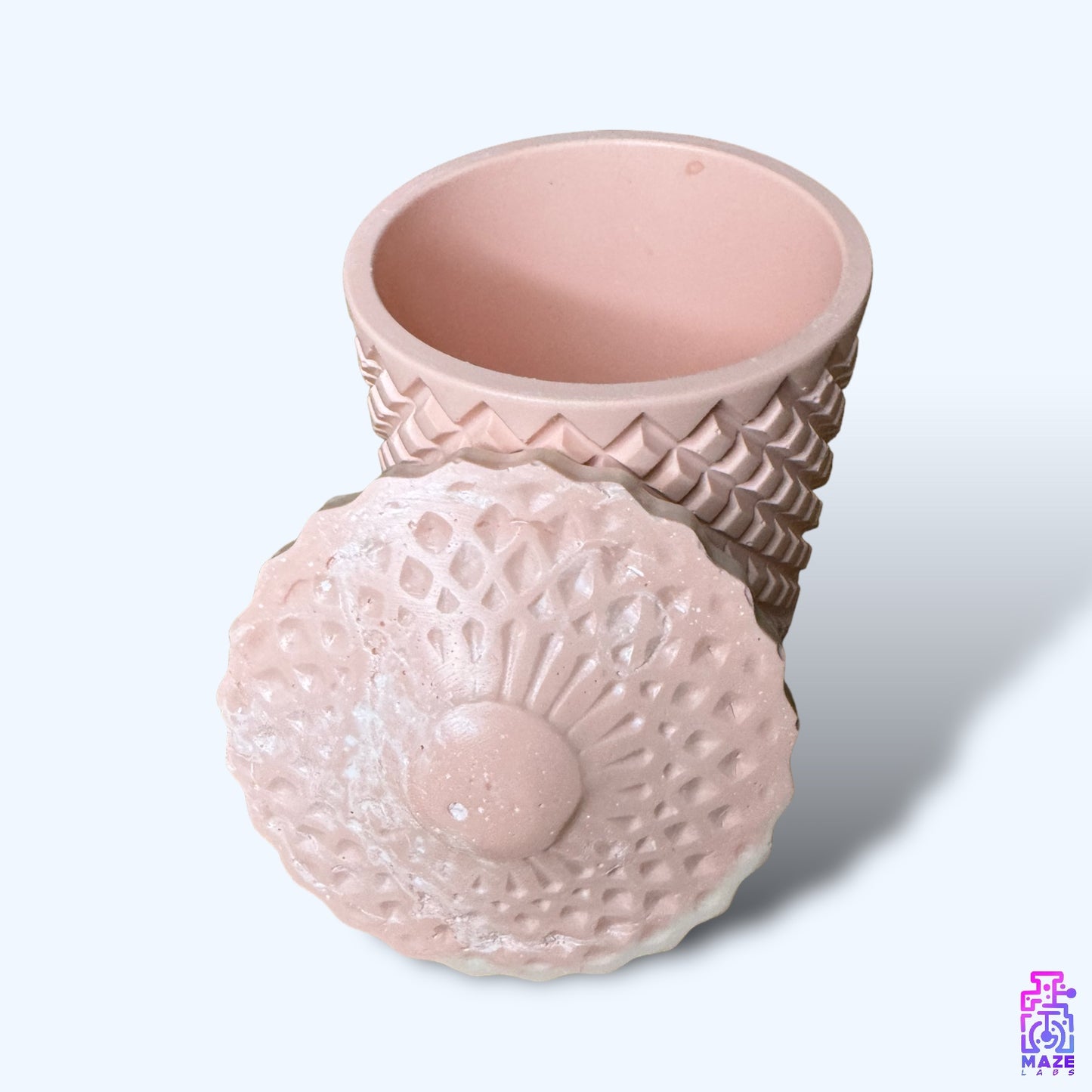 A durable Jesmonite jar with a removable lid, ideal as a jewelry organizer or decorative piece for modern interiors.