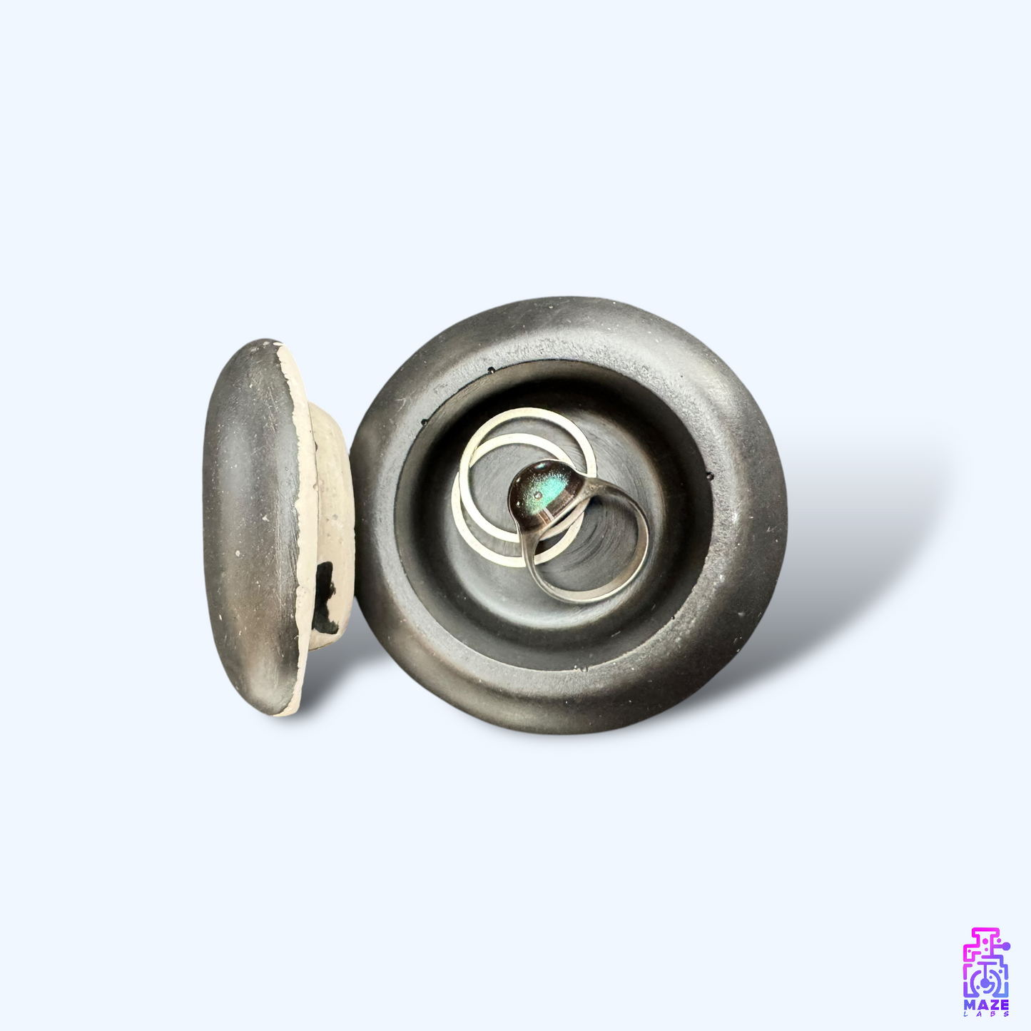 A small Jesmonite jar with an inkjet-style design, viewed from above with the lid removed, showing the open storage space.