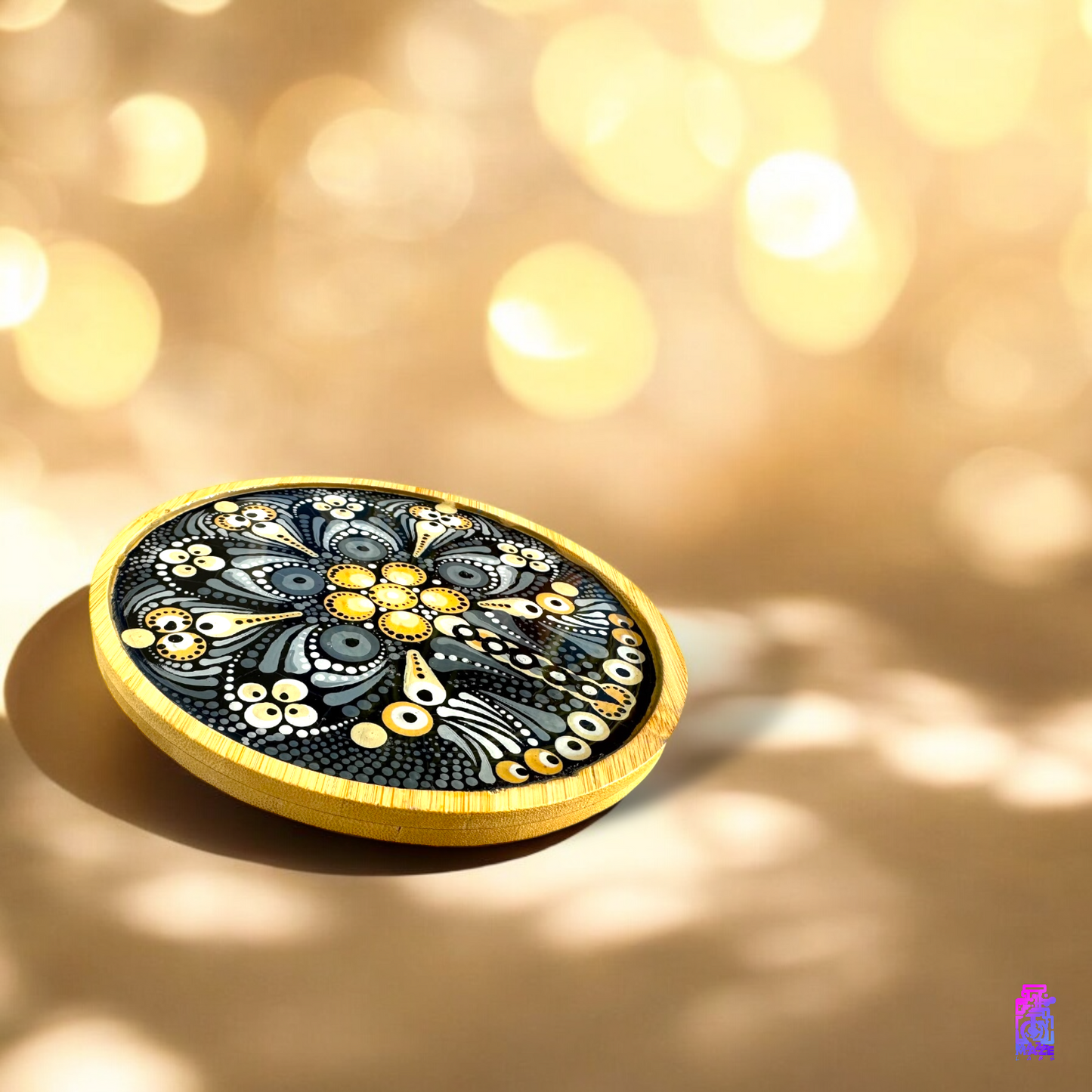 ide view of the ROOT wooden tray in black and light brown, illuminated by a warm gold light, enhancing its glossy resin finish.