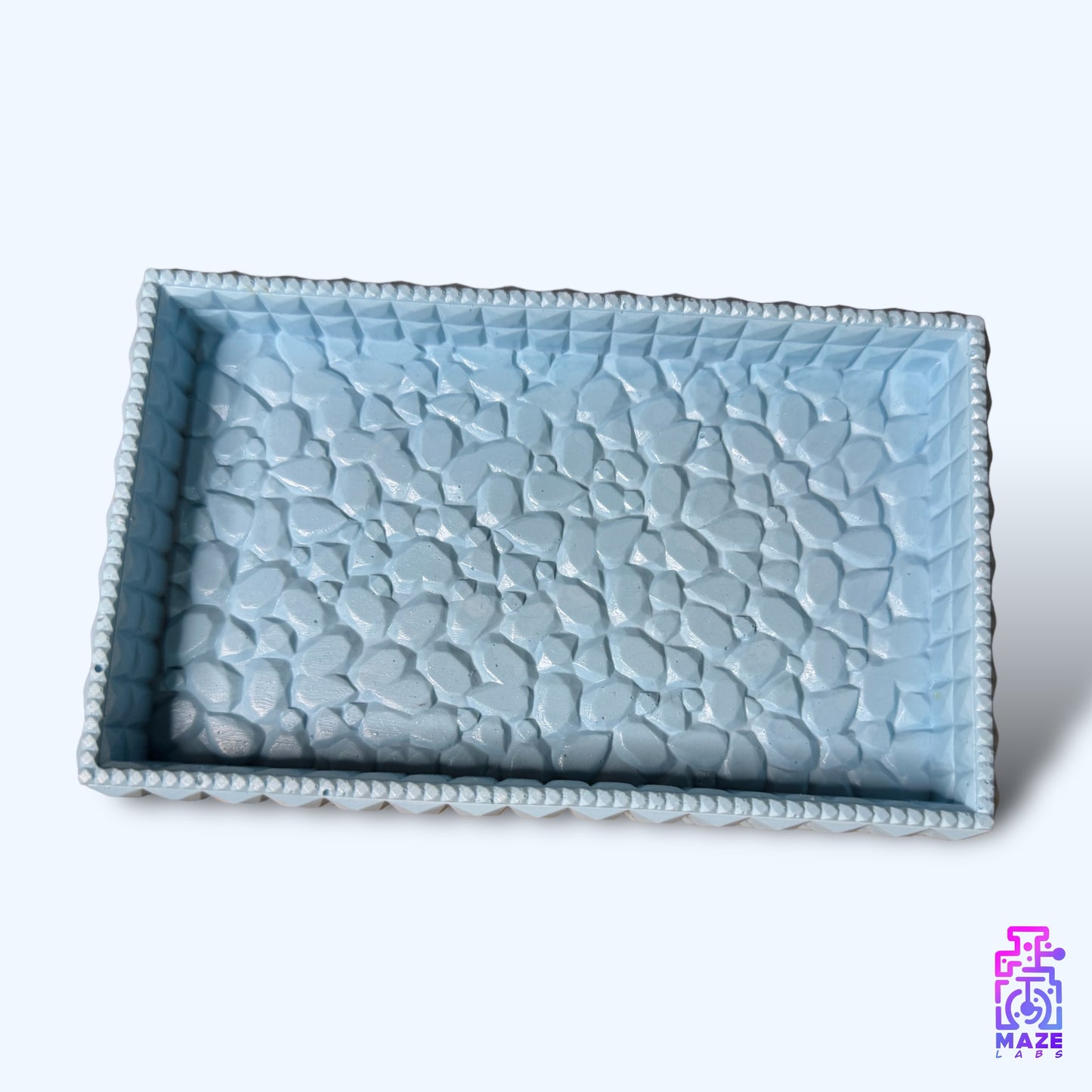 Top-down view of the TEXA tray in light blue, displaying its raised textured pattern and rectangular shape.