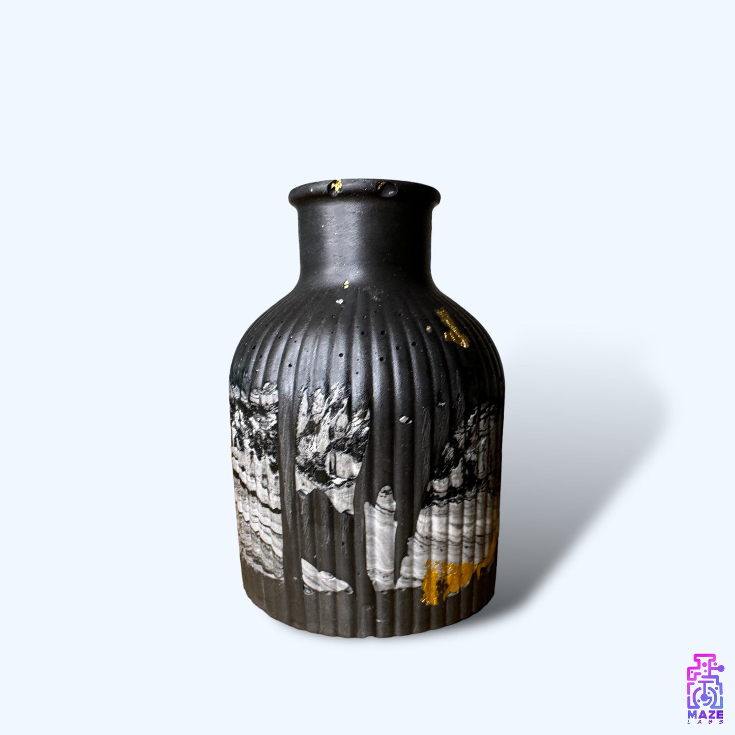 VESO black jesmonite vase with a weathered texture and subtle engraved detailing.