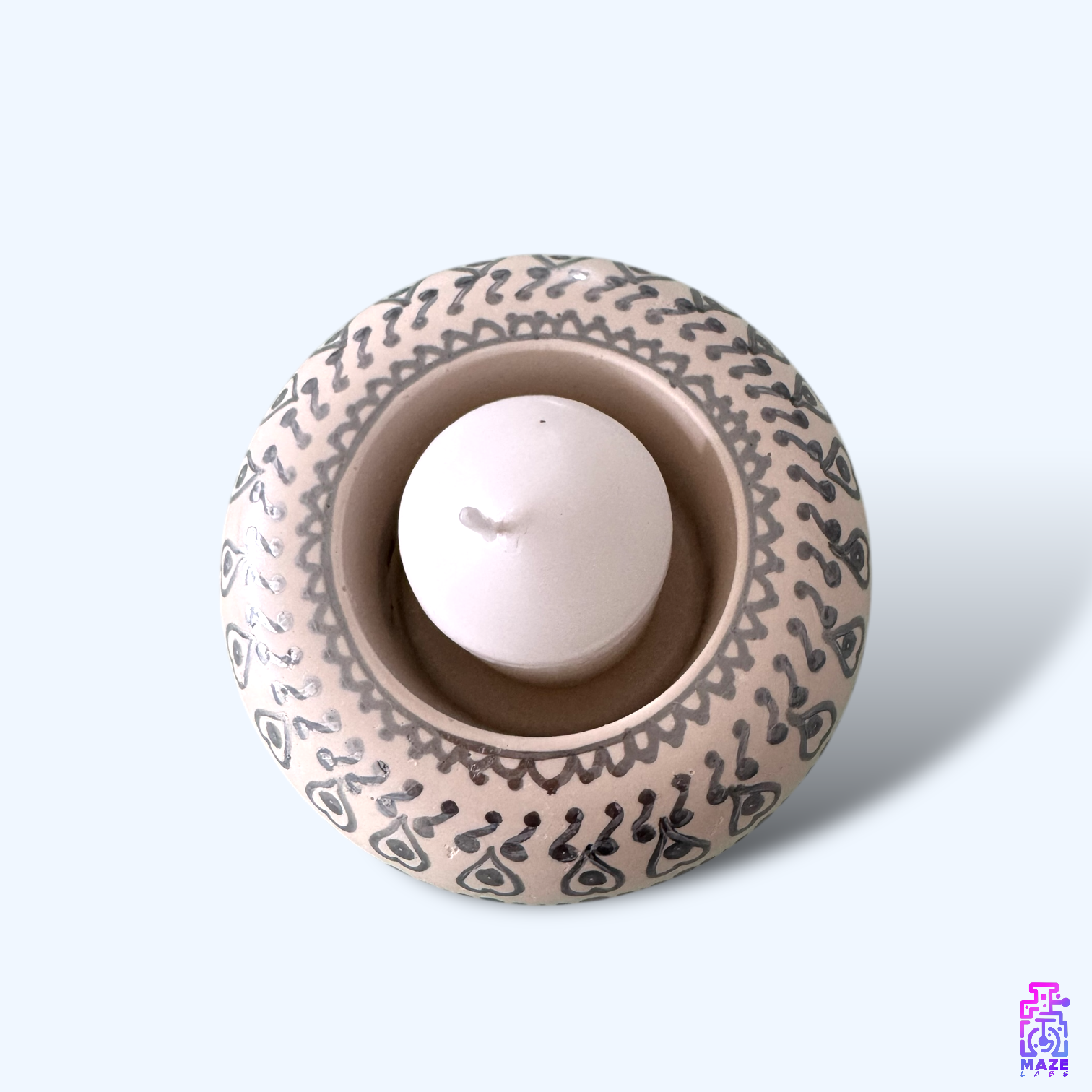 Top-down view of the DENSO candle holder, showcasing its rounded design and included candle.
