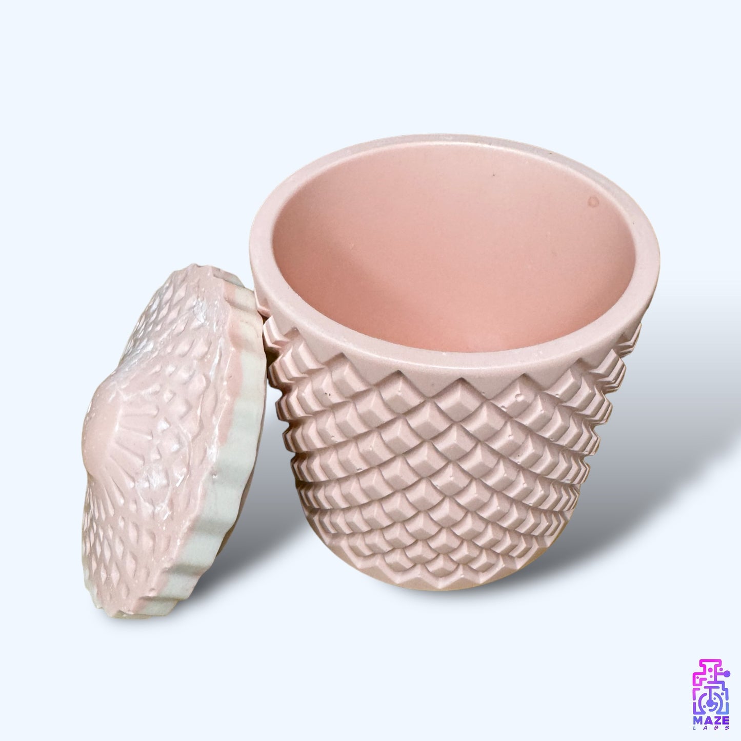 A large Jesmonite jar with a geometric lid, ideal for storing small essentials and home decor.
