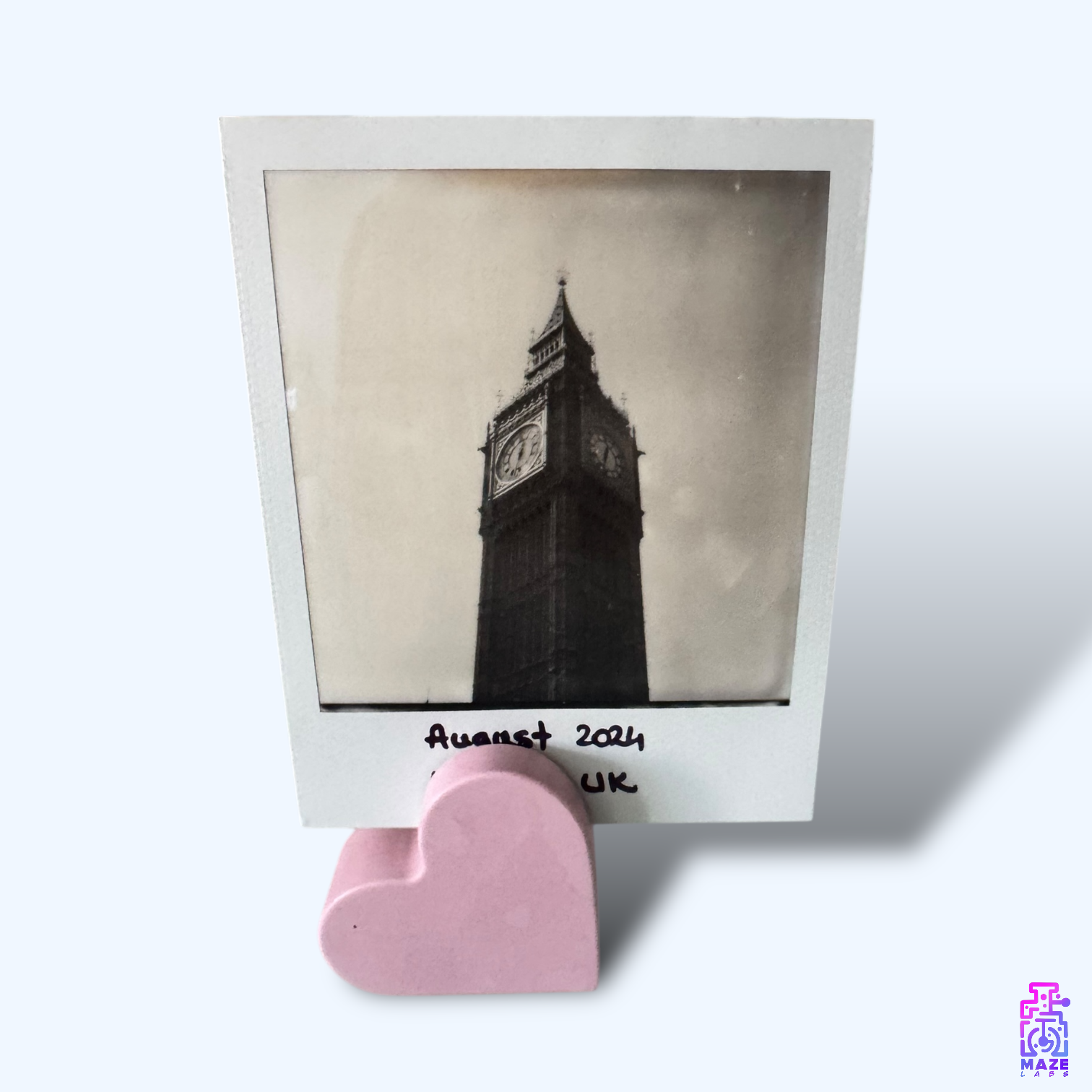 Front view of the KALB heart-shaped photo holder in soft pink jesmonite, holding a black-and-white picture.