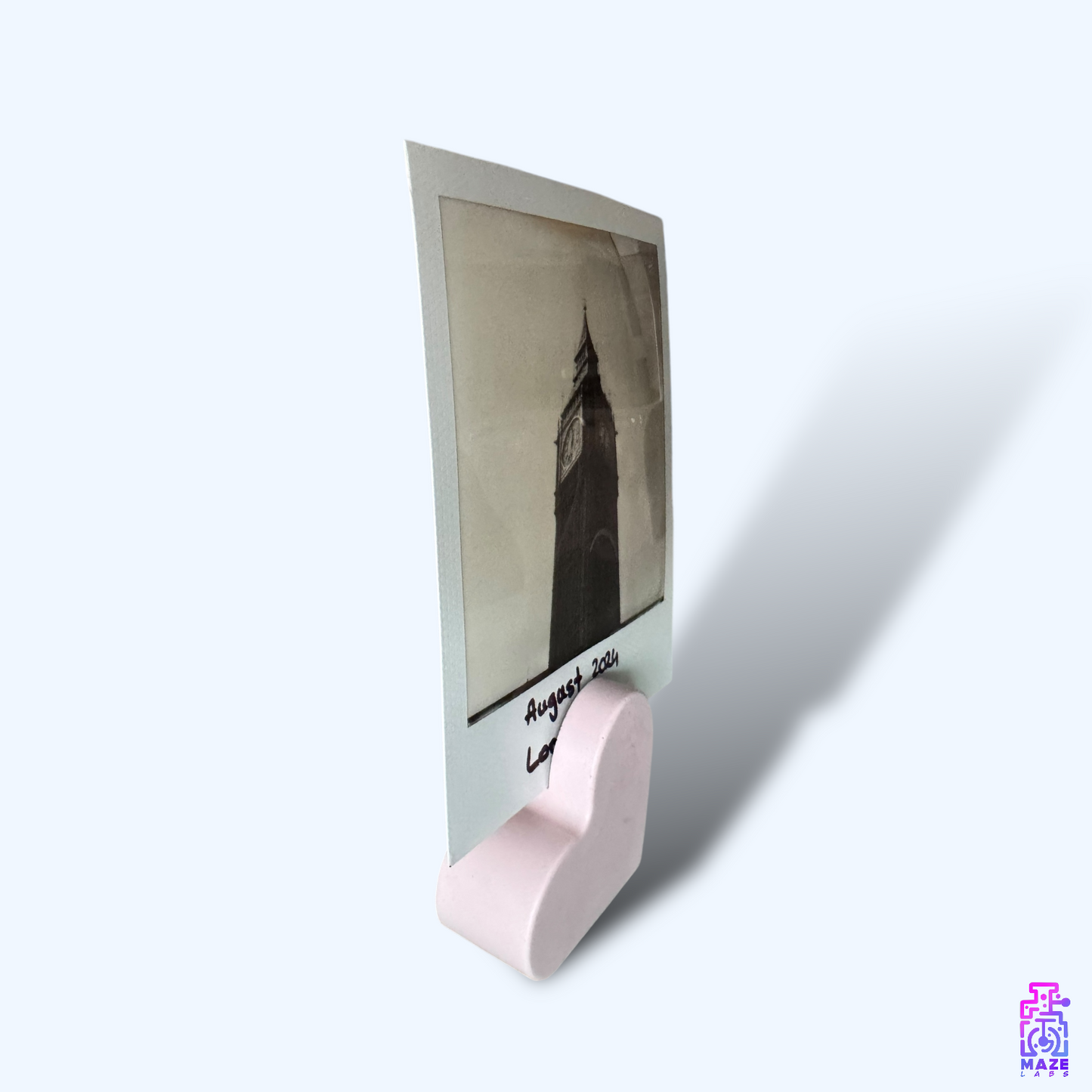 Side view of the KALB heart-shaped photo holder in soft pink jesmonite, displaying its smooth edges and minimalist design.