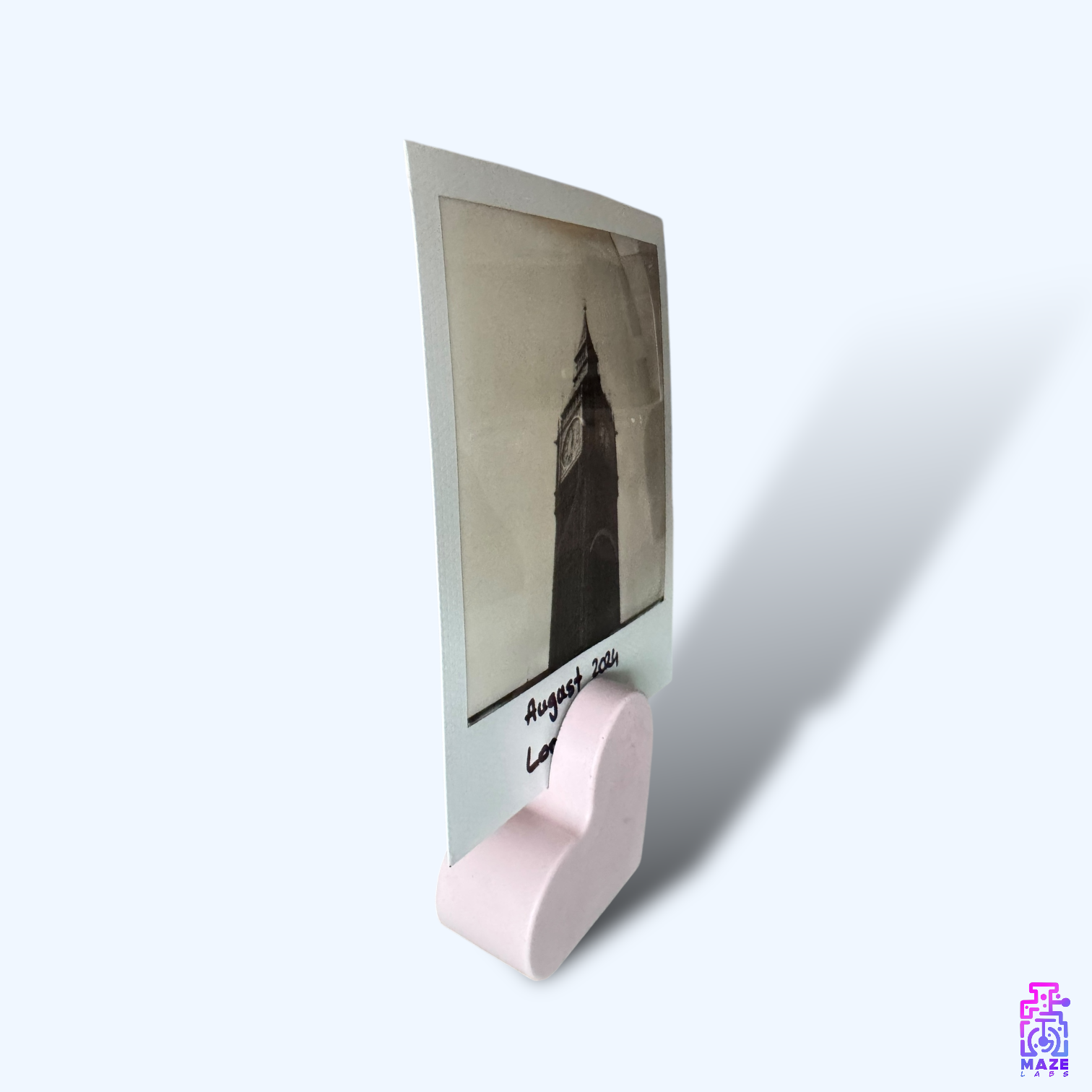 Side view of the KALB heart-shaped photo holder in soft pink jesmonite, displaying its smooth edges and minimalist design.