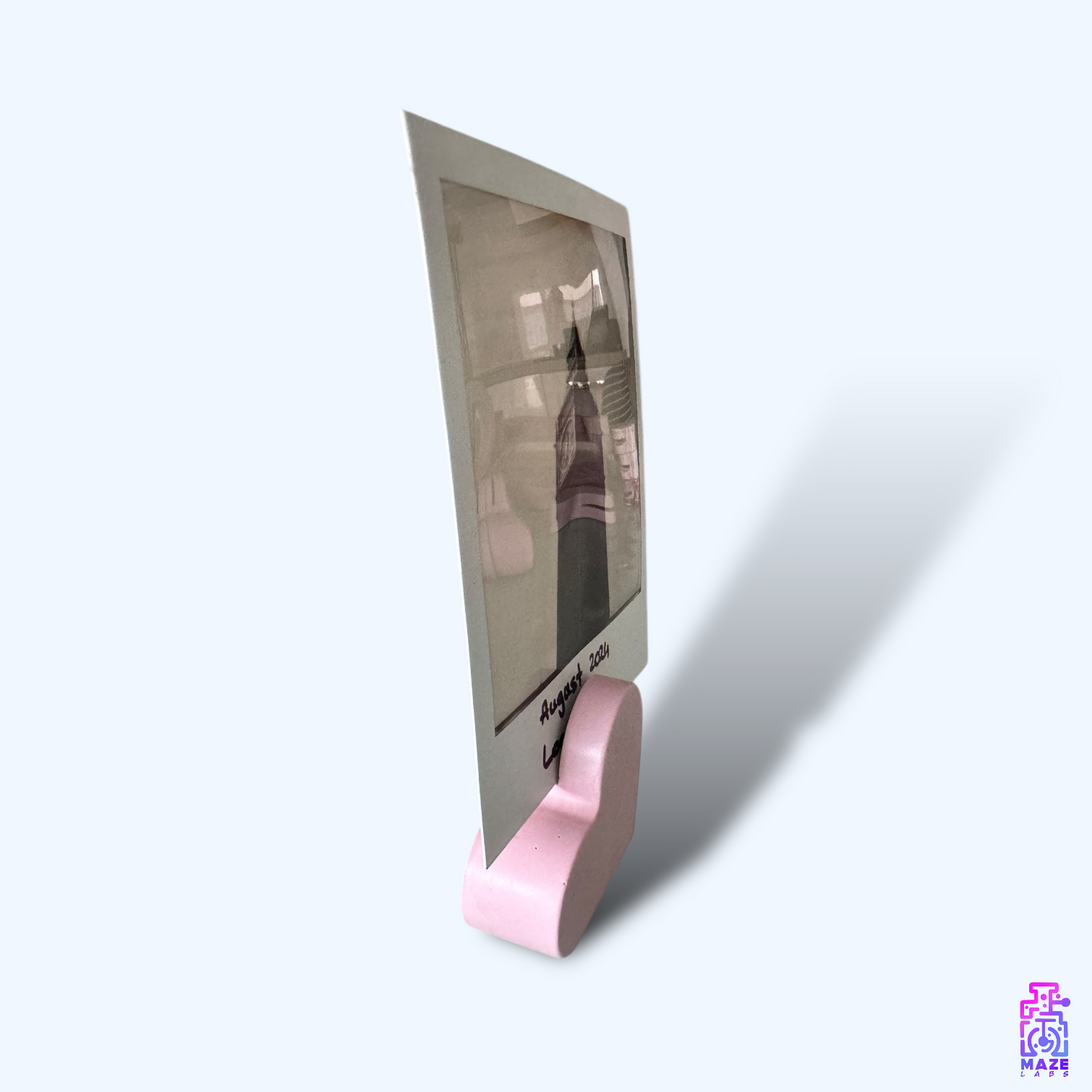 Side view of the KALB photo holder in soft pink jesmonite, showcasing its smooth heart-shaped design.