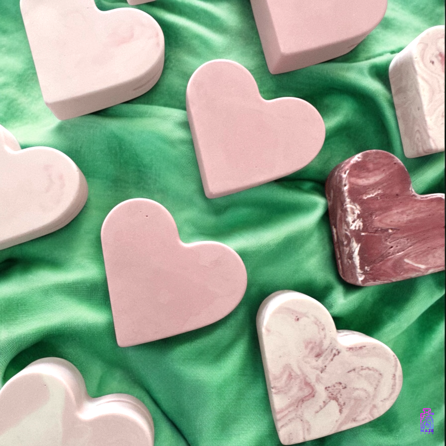 Top-down view of multiple KALB heart-shaped photo holders in different shades, arranged in a group.