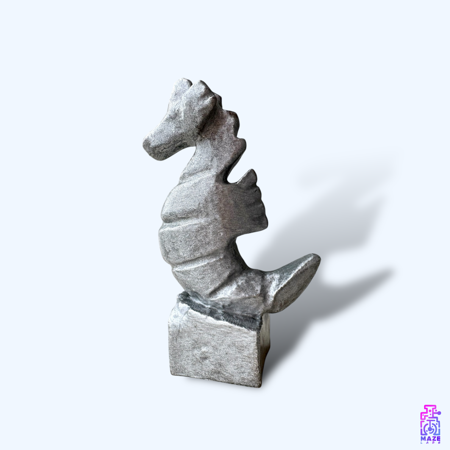 Side view of multiple KUDAKAI seahorse statuettes arranged for display, showcasing their smooth resin-coated surface.
