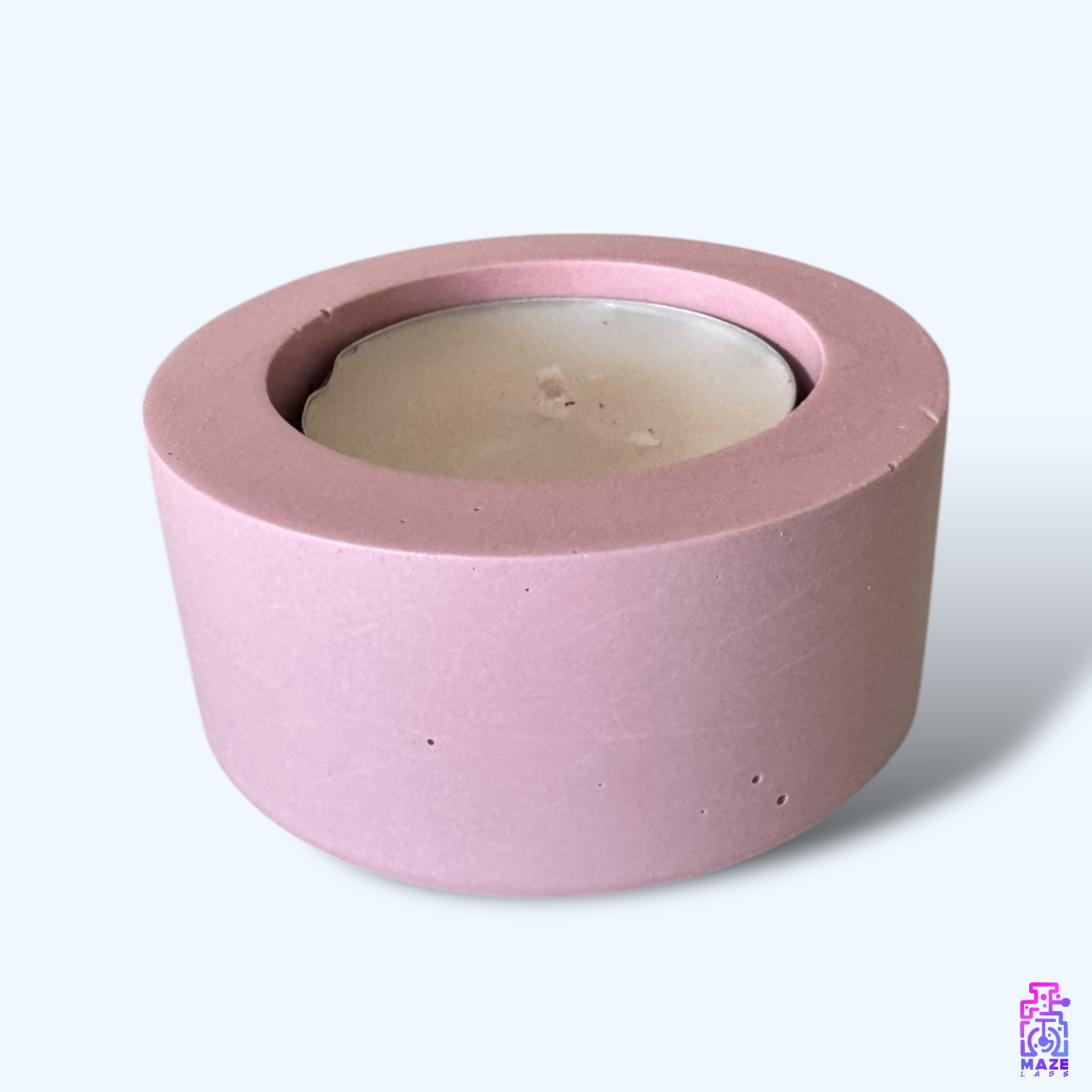 LUN single tealight candle holder made from dark pink eco-friendly jesmonite, displayed on a clean white background with a candle.