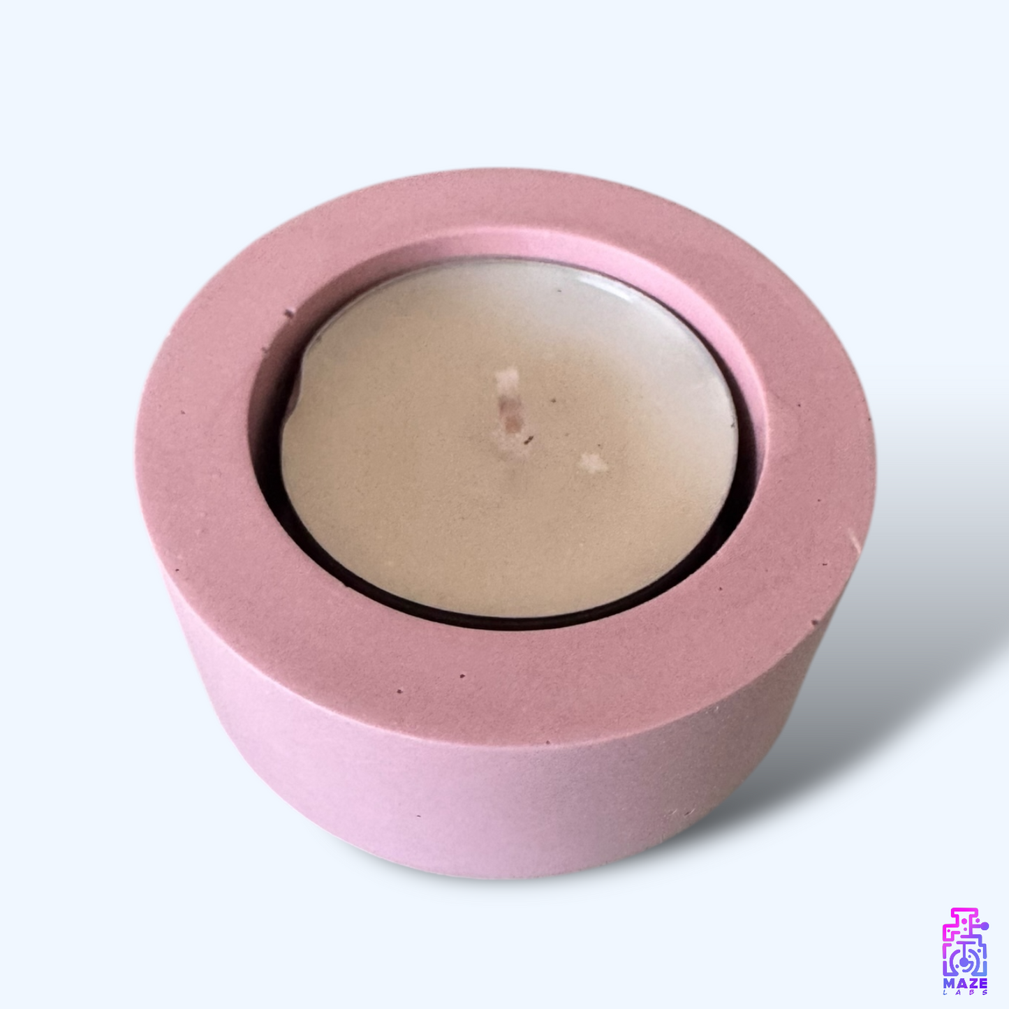 LUN single tealight candle holder in dark pink jesmonite, photographed from a top-down angle showcasing its round shape and the tealight candle included.