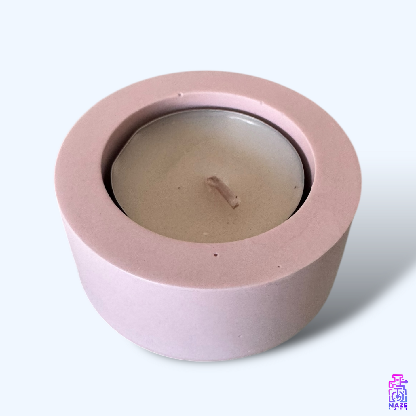 LUN single tealight candle holder in light pink jesmonite, captured from a top-down angle showcasing its round shape and deep candle slot.