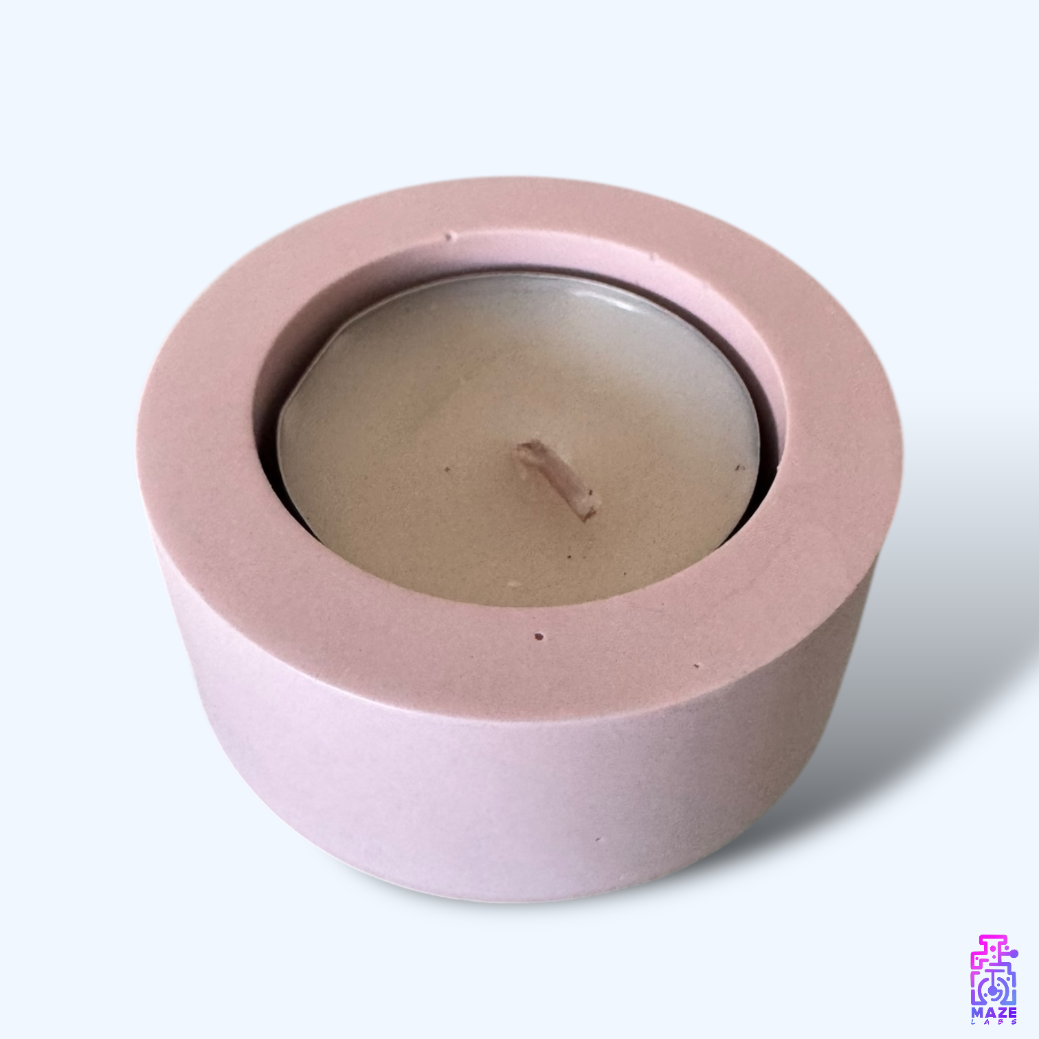 LUN single tealight candle holder in light pink jesmonite, captured from a top-down angle showcasing its round shape and deep candle slot.