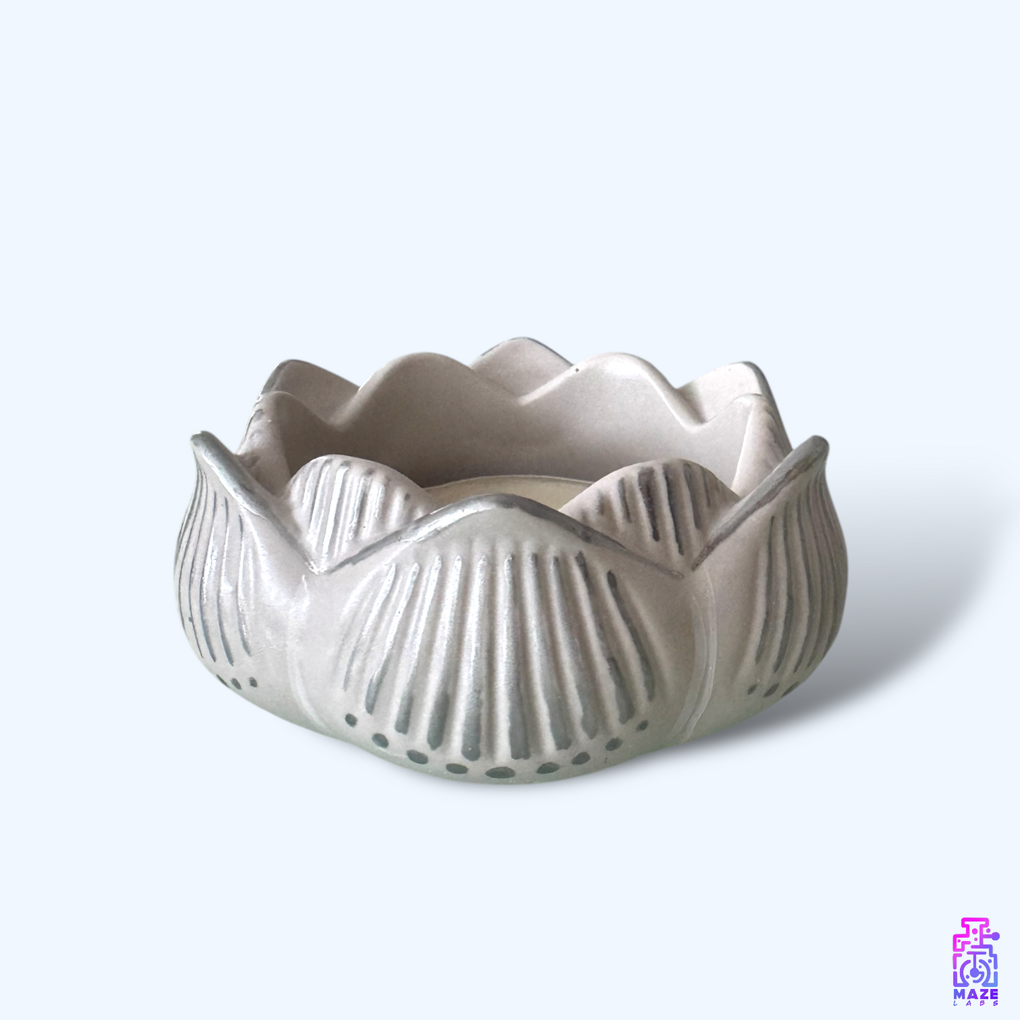 Side view of the NALA tealight holder, highlighting its sculpted form and handmade details.