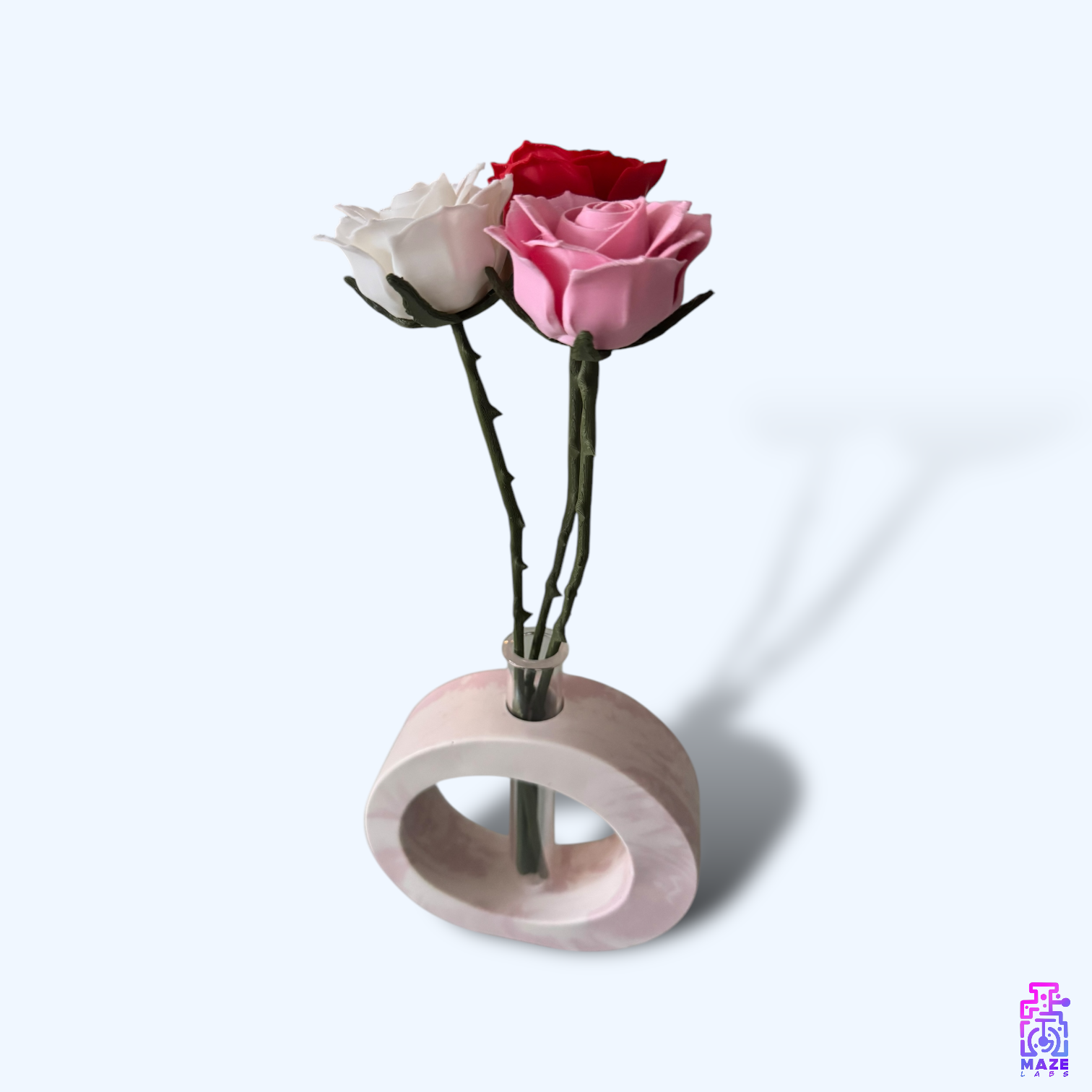 OHM vase in soft pink jesmonite, featuring a circular form with inserted flowers in the plastic tube.