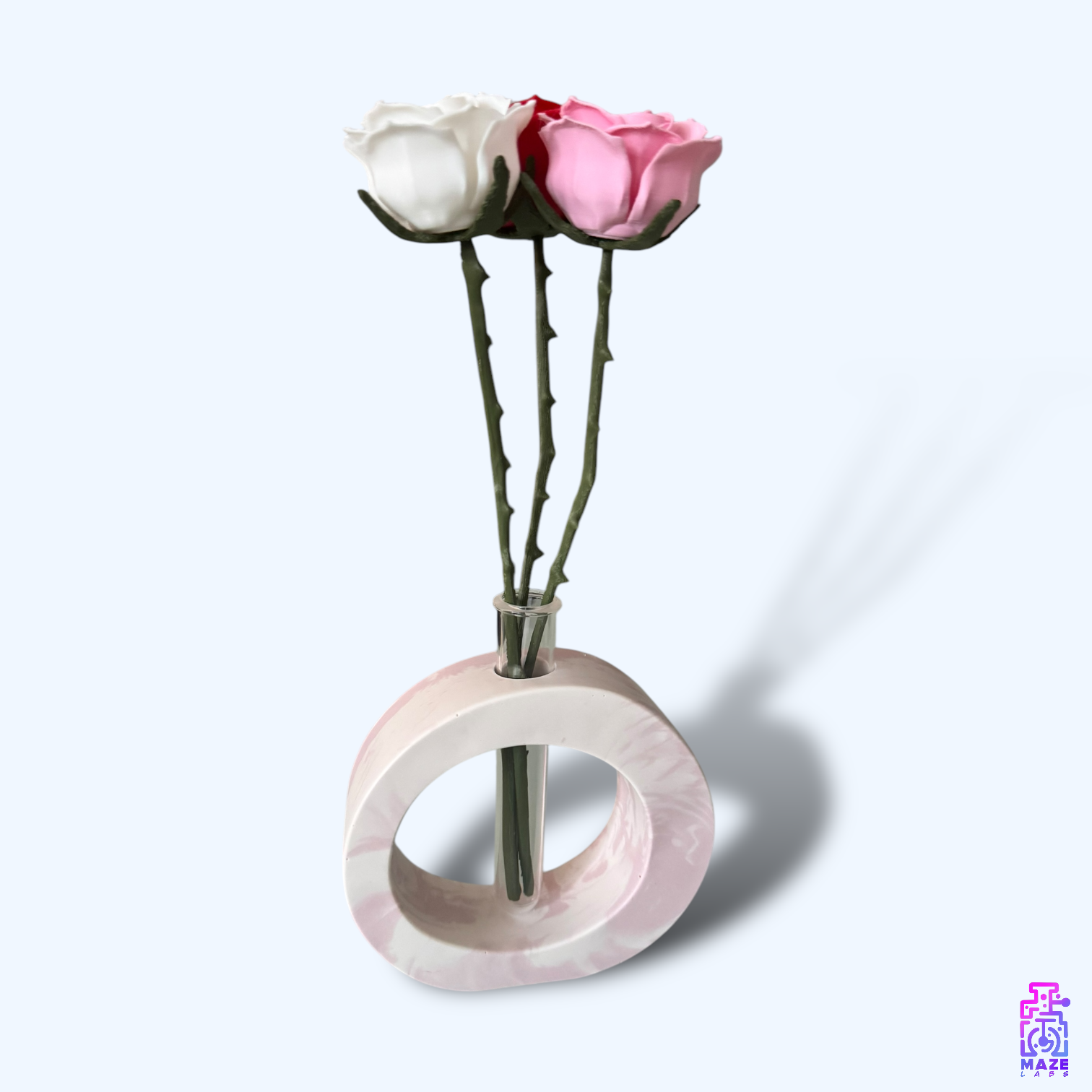 Side view of the OHM vase in pink jesmonite, showcasing its sleek circular design
