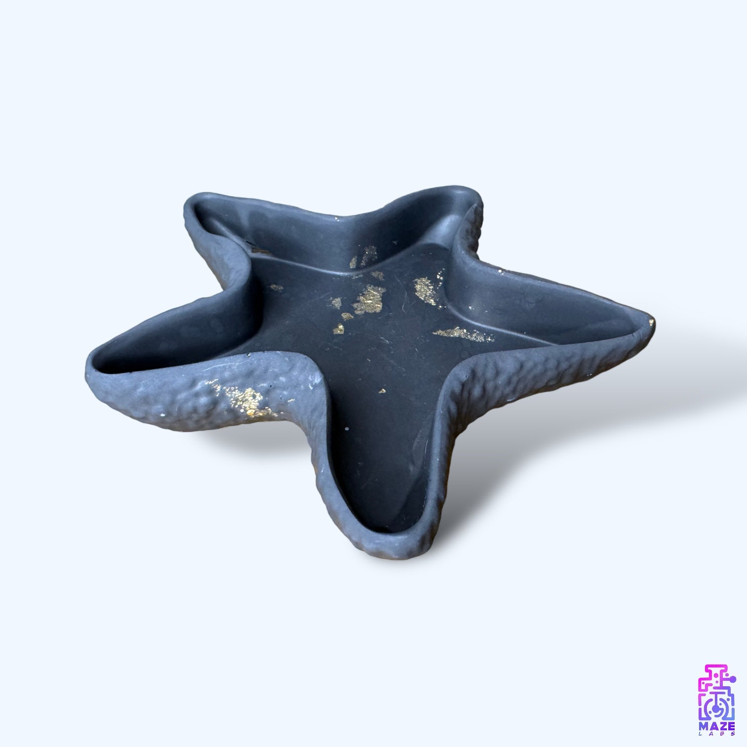 Angled view of the ORIX tray, showing its sculptural starfish form with smooth, organic edges.