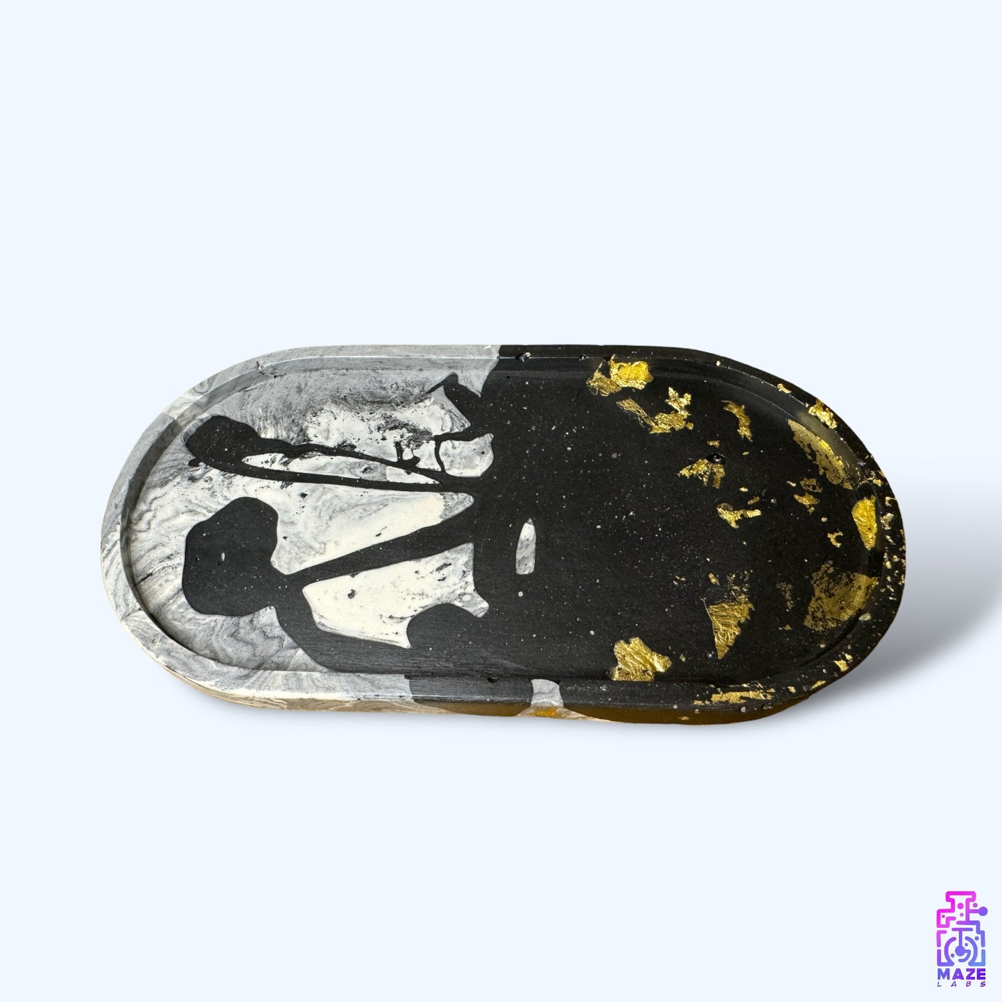 OVA medium oval tray made from eco-friendly jesmonite, featuring a black and gray base with gold accents.