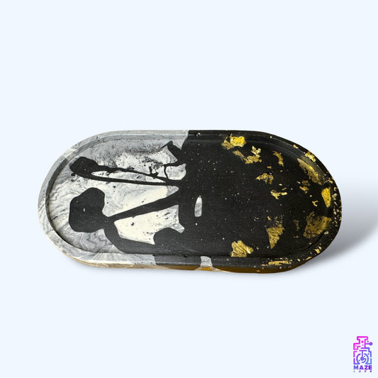 OVA medium oval tray made from eco-friendly jesmonite, featuring a black and gray base with gold accents.