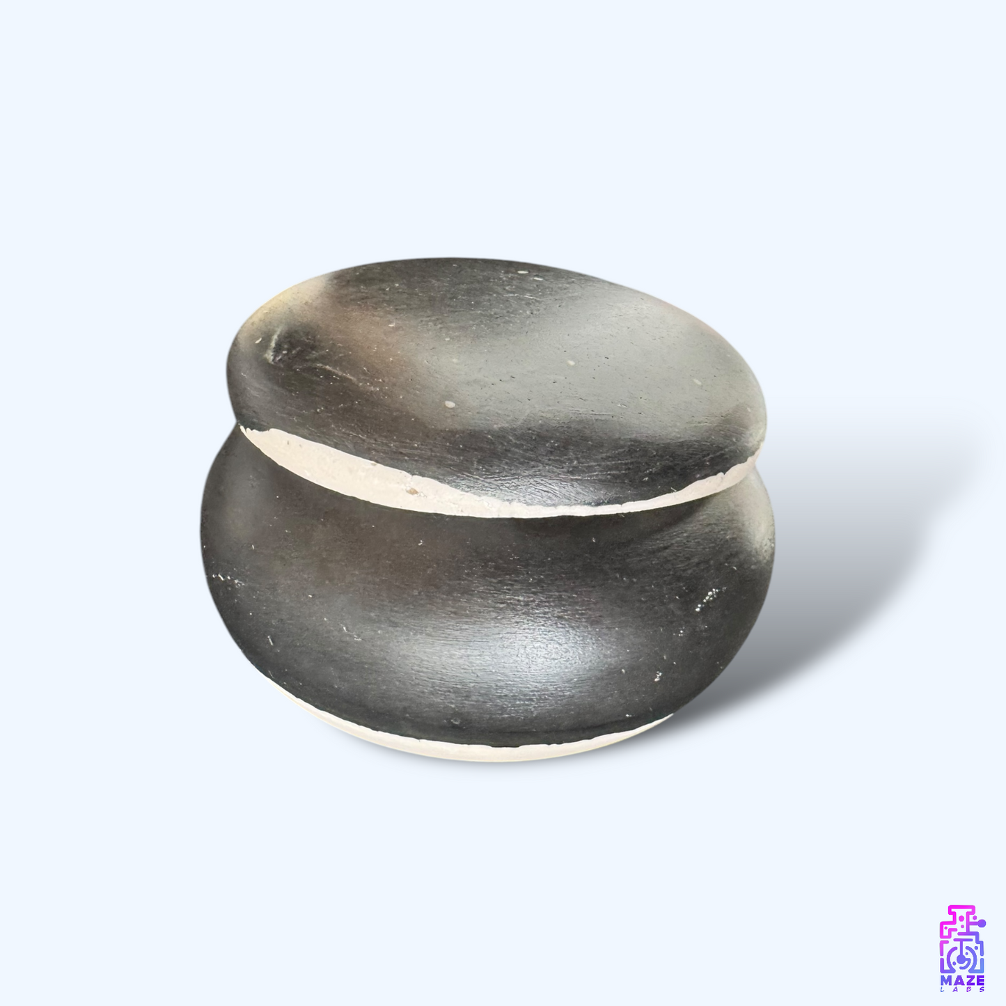 A minimalist Jesmonite jar with a snug-fitting lid, displayed from a side angle for a clear view of its rounded shape.