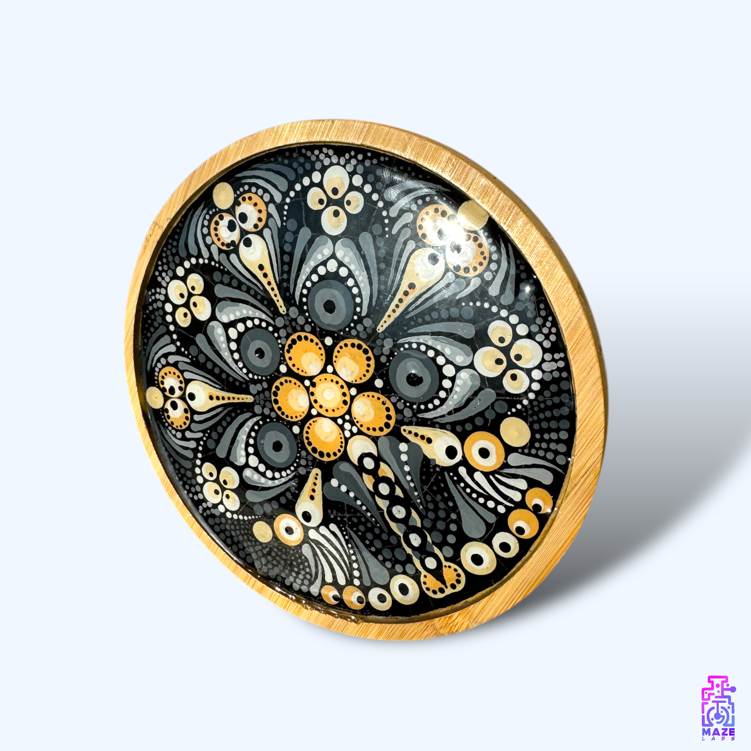 Angled top view of the ROOT wooden tray in black and light brown, showcasing its detailed mandala artwork and smooth resin-coated surface.