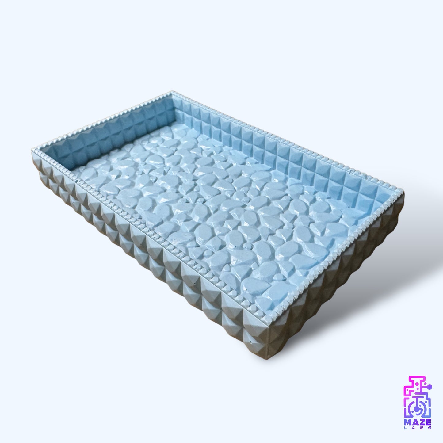 Angled perspective of the TEXA tray in a light blue finish, highlighting its textured surface and sleek rectangular shape.